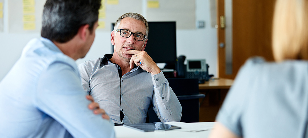 Shot of three colleagues having a meeting in an office